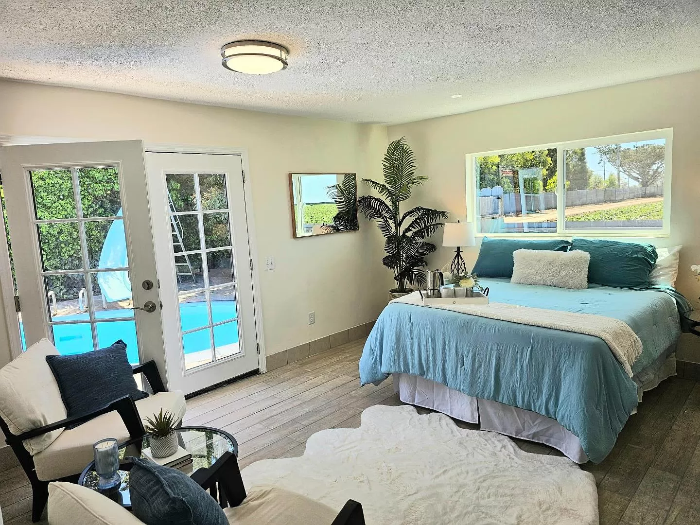 Primary bedroom (~12×16) with pool access and views.