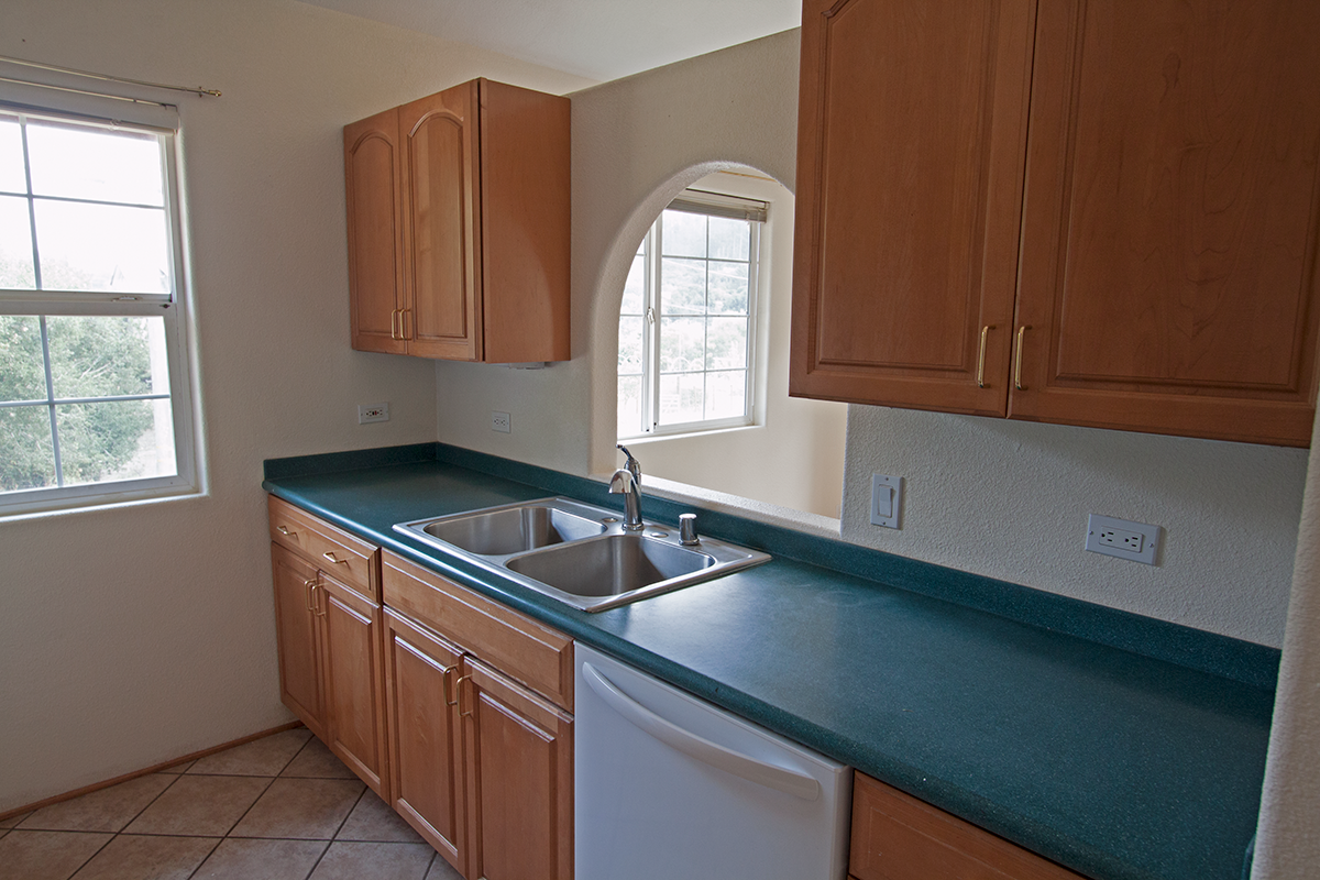 Bright kitchen with plenty of cabinets and dishwasher.
