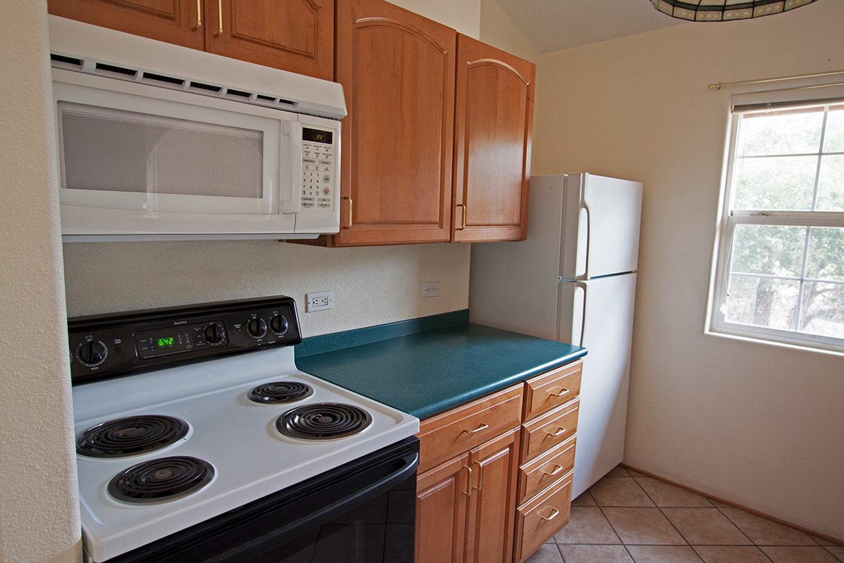 Full kitchen with built-in microwave over the stove.