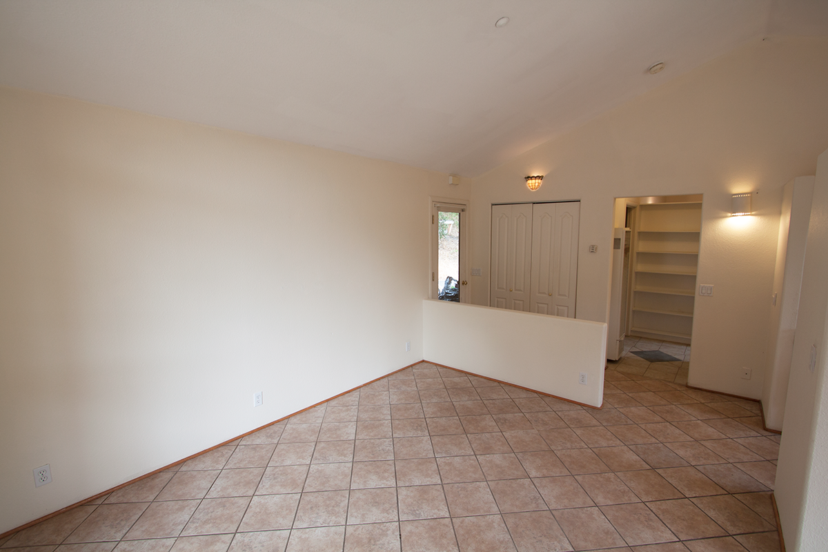 Large living room; side door to laundry room just outside.
