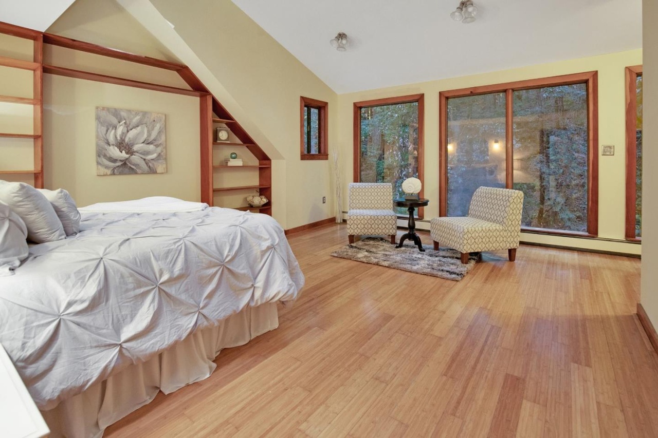 Primary bedroom faces the creek; new bamboo flooring.