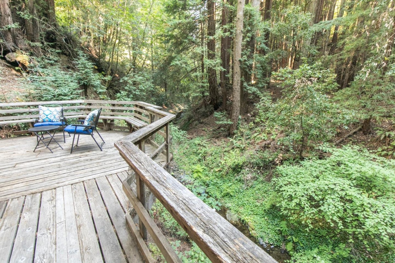 Wraparound deck with morning sun over the creek.