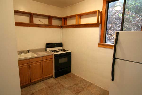 Kitchen with gas range and refrigerator.