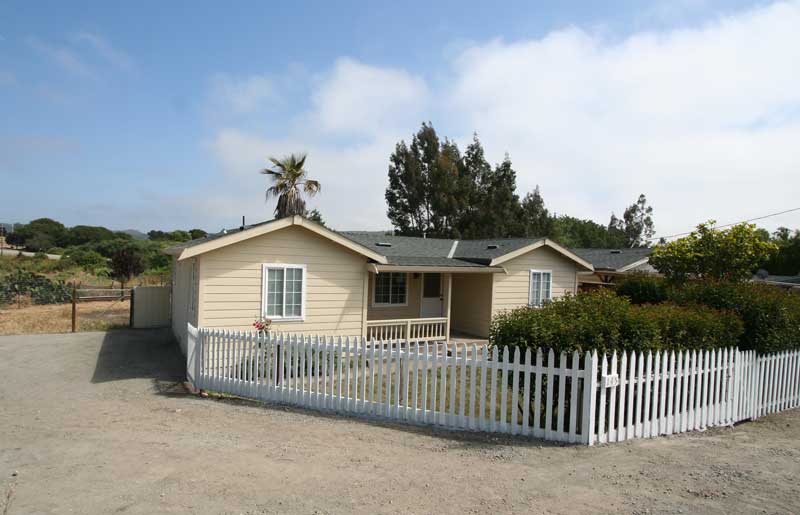 Fenced front yard with covered porch.