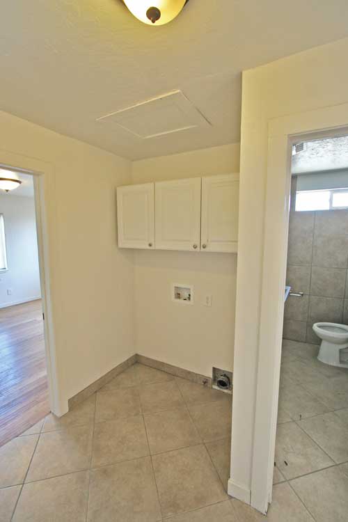 Hall laundry room set up for gas dryer.