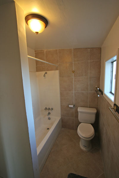 Spacious tiled bathroom.