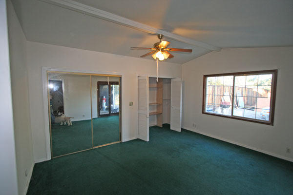 Primary bedroom opens to covered porch; two huge closets.