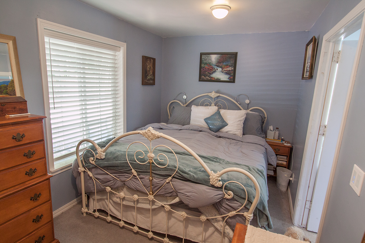 Lower bedroom ~8×16 with new carpet.