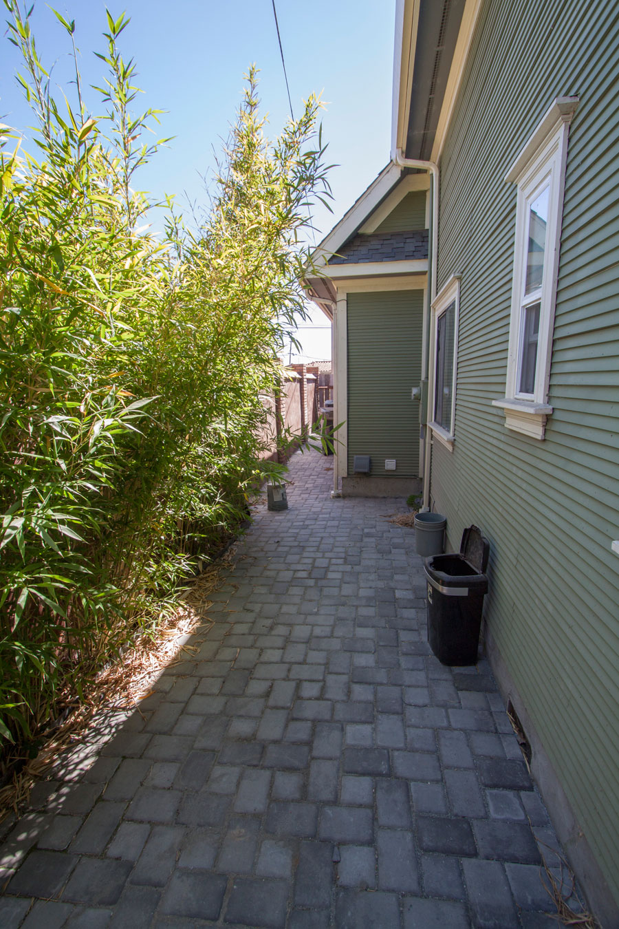 Side walkway and gate to front parking for yard access.