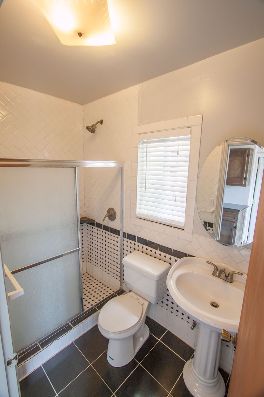 Guest bath with full-size shower and grab bars.