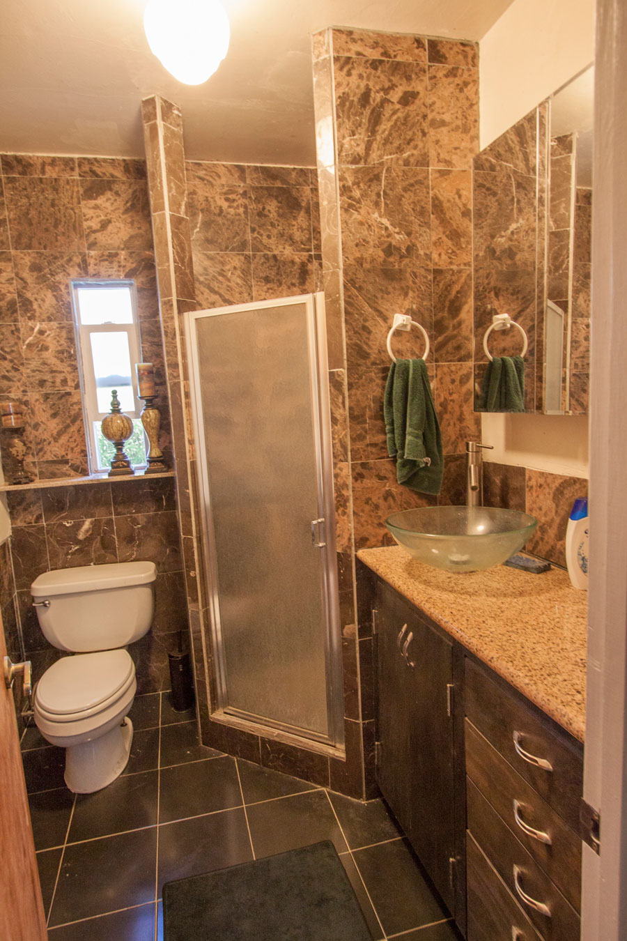 Bath next to the third bedroom—granite/marble, lots of storage.