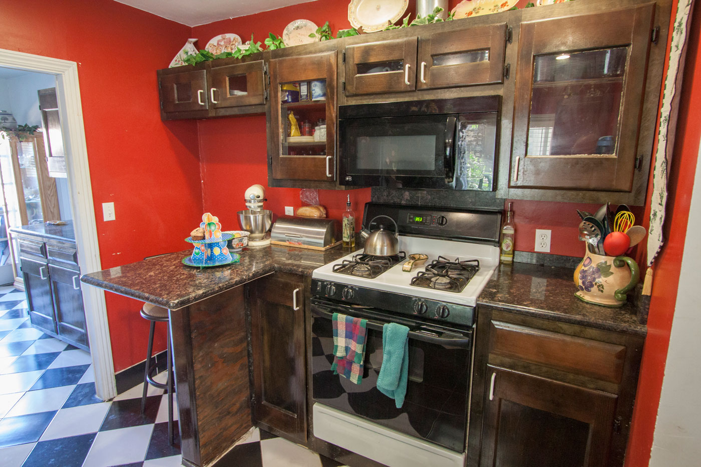Gas range with microwave; breakfast bar; extra storage in hall.