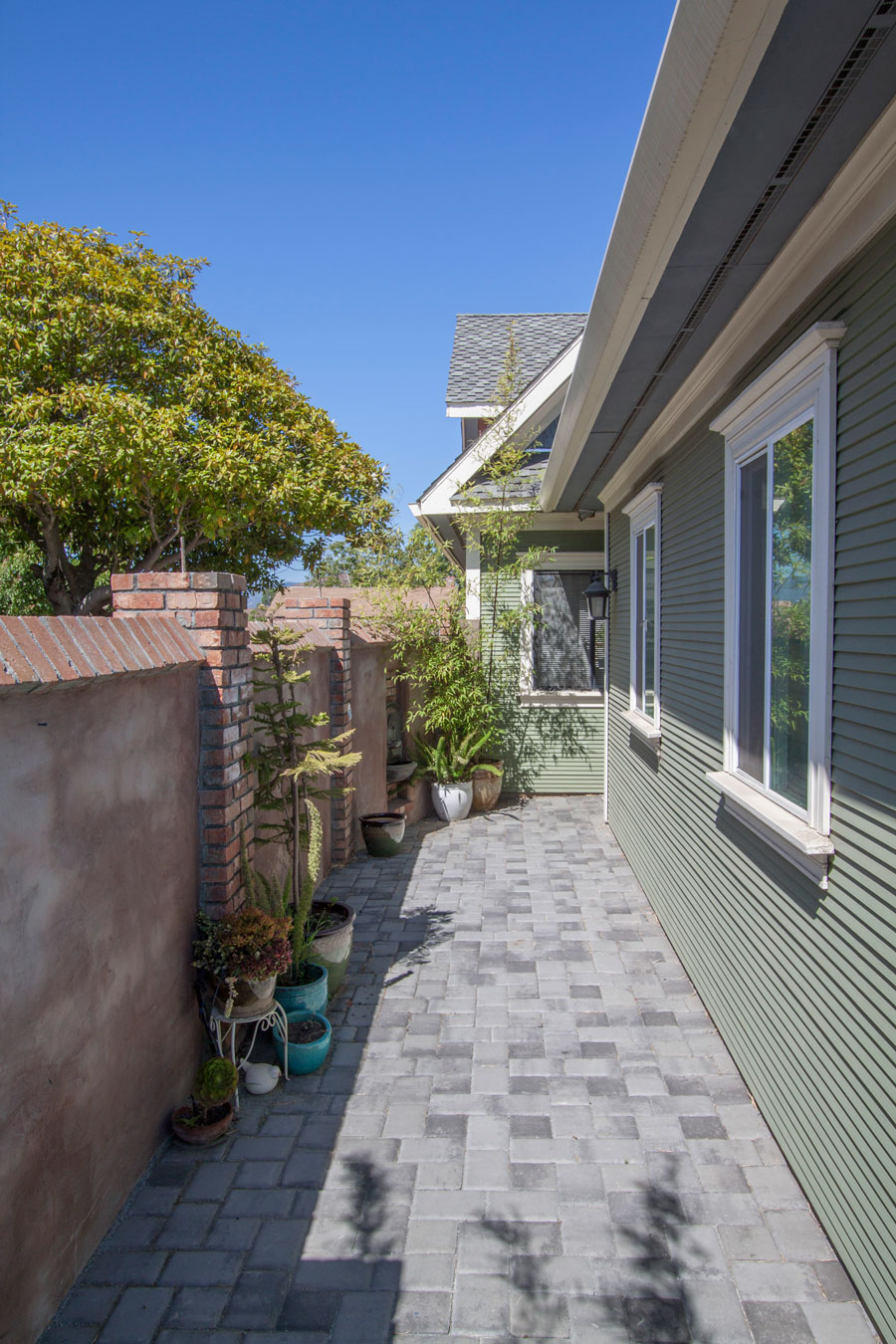 Walkway courtyard to front door; posts have drip irrigation.