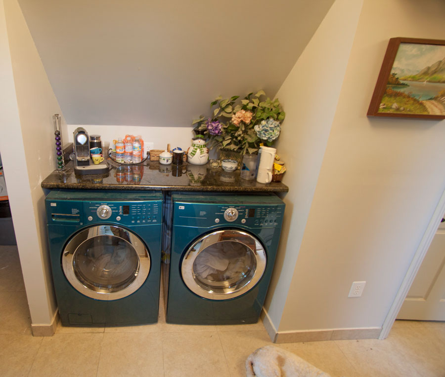 Suite laundry with granite—no hauling clothes downstairs.