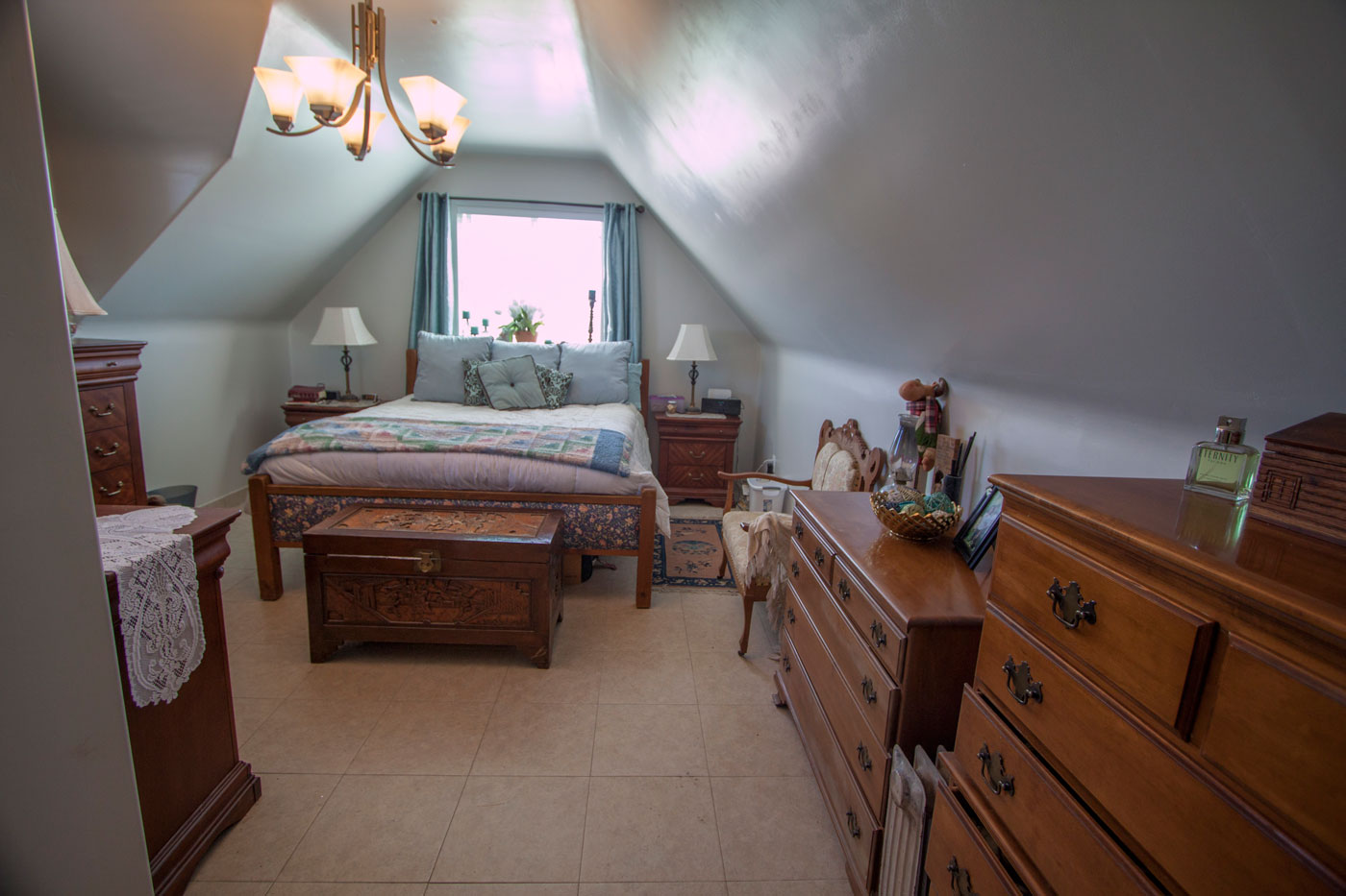 Upstairs master bedroom ~19×16 with sloped ceilings.