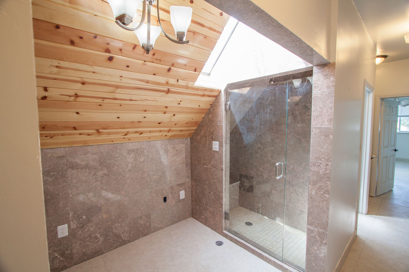 Marble shower room with two heads and on-demand hot water.