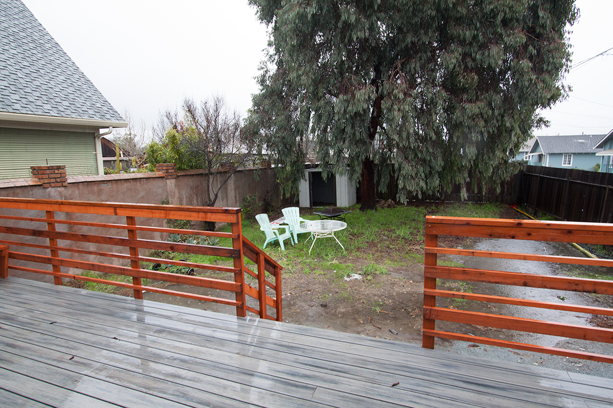Fenced backyard with mature tree and lots of potential.