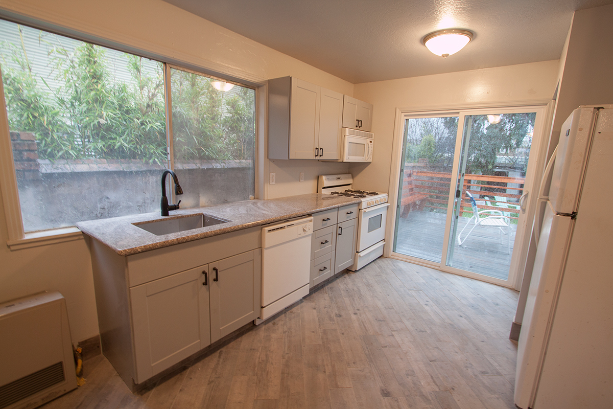 New kitchen with vented microwave hood, dishwasher, and granite.